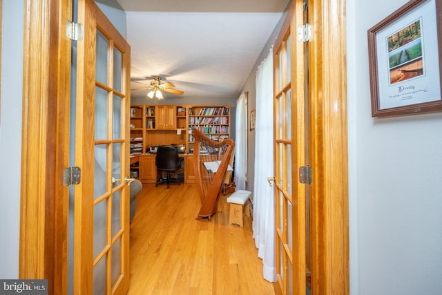 hallway featuring light hardwood / wood-style flooring and french doors