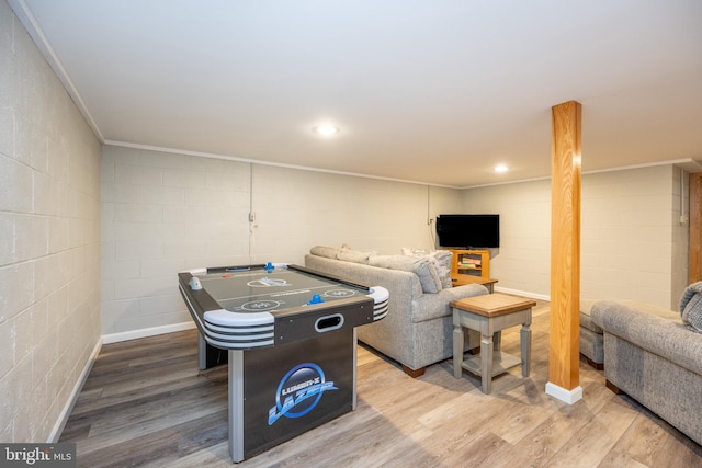 recreation room with hardwood / wood-style flooring and ornamental molding