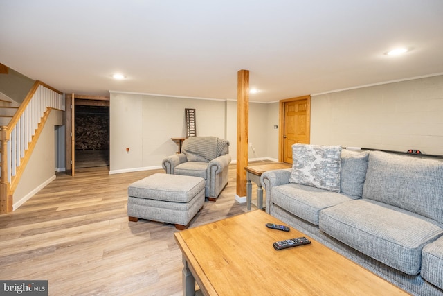 living room with crown molding and light wood-type flooring