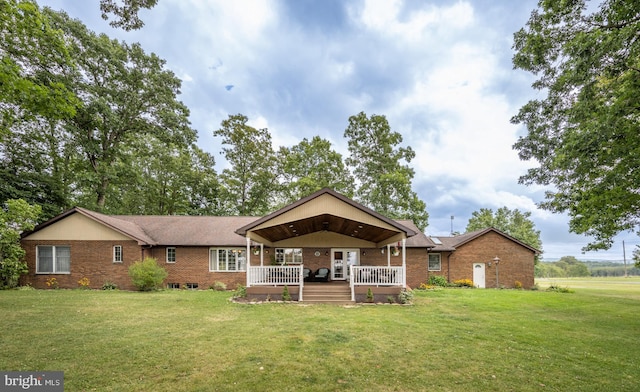 rear view of property with a deck and a lawn