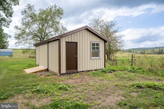 view of outbuilding featuring a yard