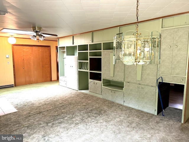 carpeted spare room featuring ceiling fan with notable chandelier and baseboard heating