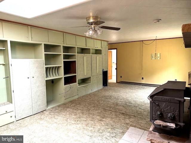 tiled living room featuring a baseboard heating unit and ceiling fan