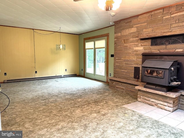 unfurnished living room with a wood stove, crown molding, a baseboard heating unit, and light colored carpet