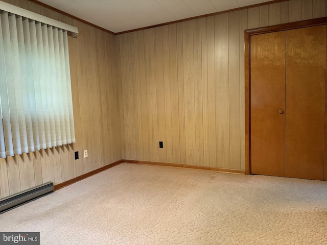 unfurnished bedroom with a baseboard radiator, a closet, ornamental molding, and light colored carpet