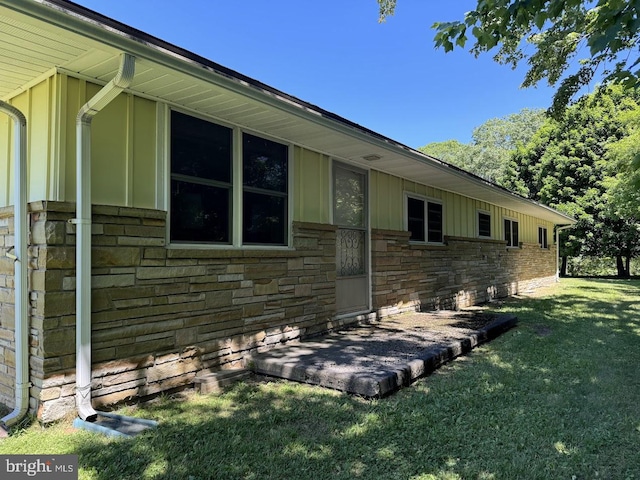 view of side of home featuring a lawn