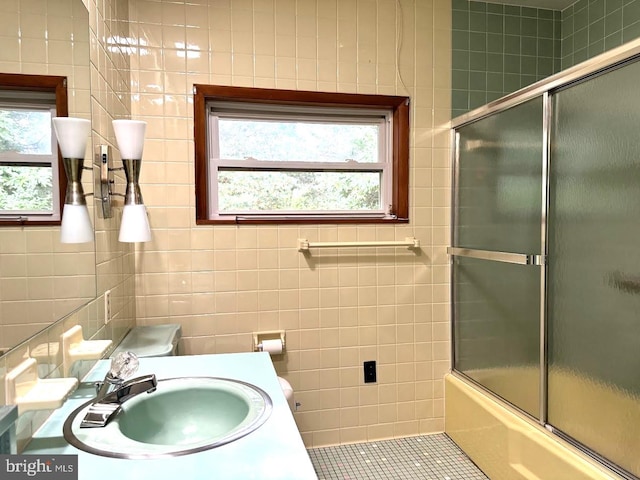 bathroom featuring plenty of natural light and tile walls