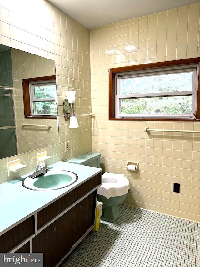 bathroom featuring tile walls, a wealth of natural light, and vanity