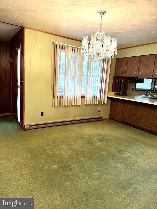 unfurnished dining area with a notable chandelier, sink, baseboard heating, and light colored carpet