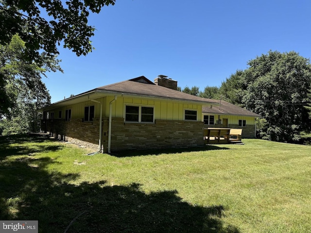 view of side of home with a lawn