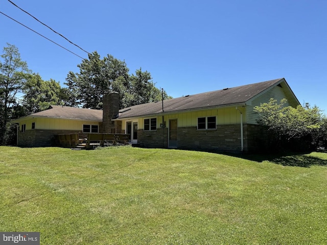 rear view of property with a lawn