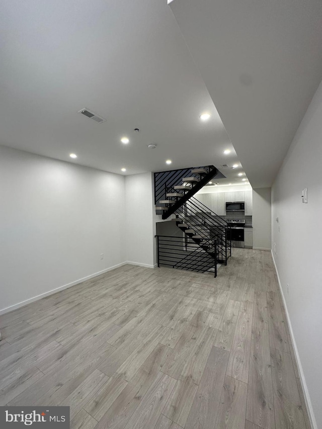 basement featuring light wood-type flooring