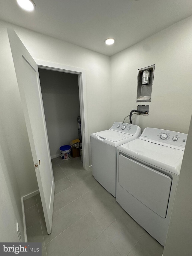 laundry area featuring light tile patterned flooring and separate washer and dryer