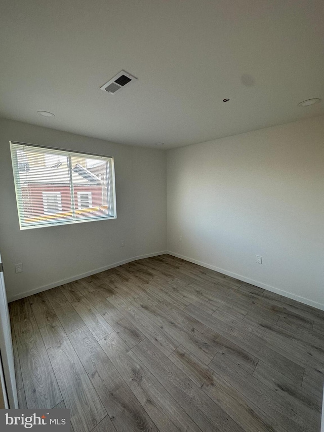 unfurnished room with light wood-type flooring