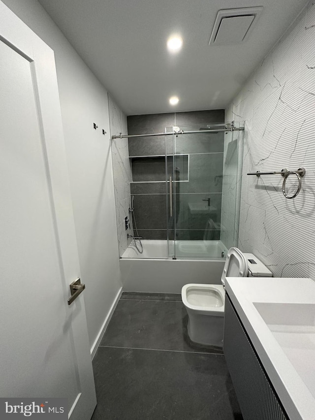 full bathroom with vanity, shower / bath combination with glass door, and toilet