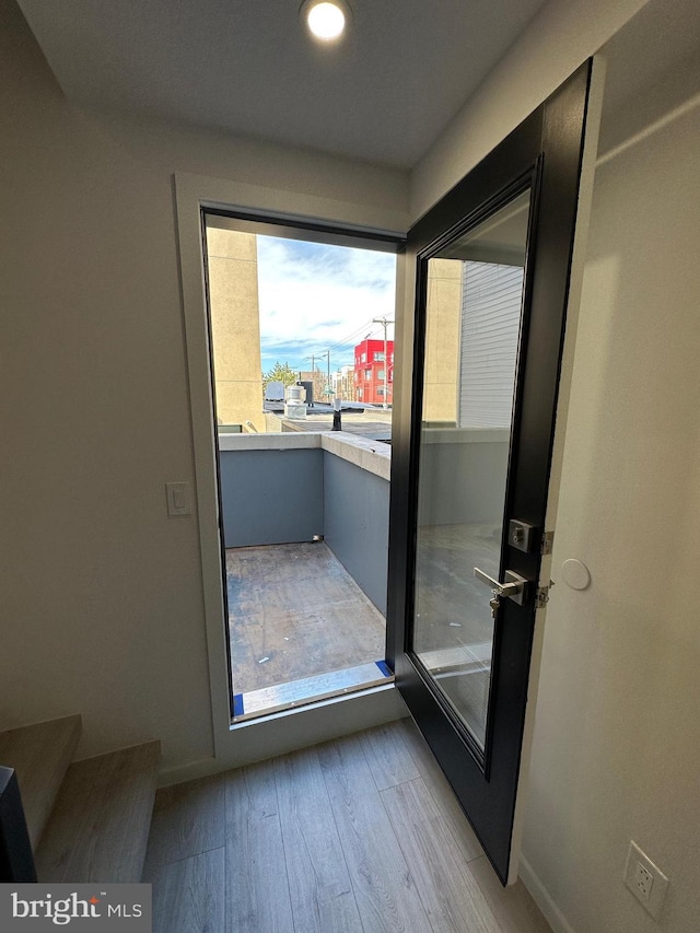 doorway to outside featuring light wood-type flooring