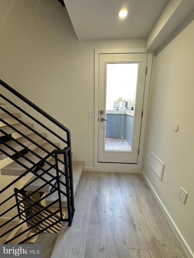 doorway to outside with light hardwood / wood-style floors