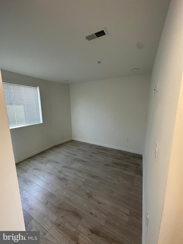 empty room with hardwood / wood-style flooring