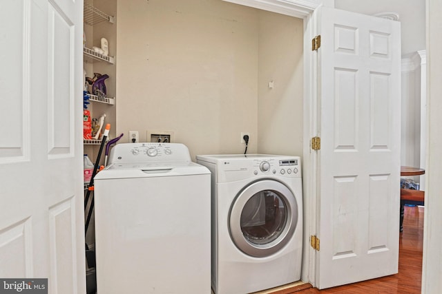 laundry area with independent washer and dryer and hardwood / wood-style floors