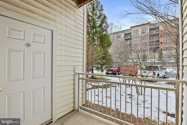 view of snow covered back of property