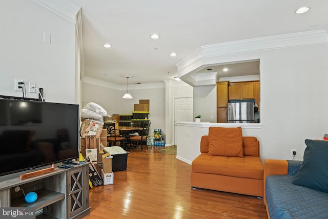 living room featuring crown molding and light hardwood / wood-style flooring