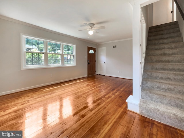 entryway featuring light hardwood / wood-style flooring, ornamental molding, and ceiling fan