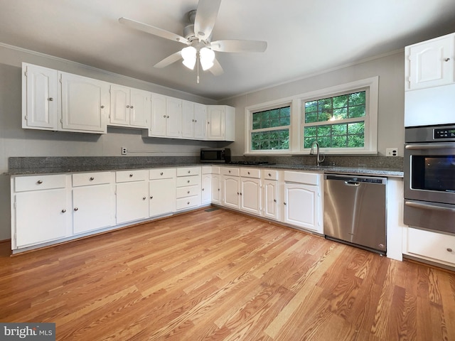 kitchen with white cabinetry, ceiling fan, stainless steel appliances, and light wood-type flooring