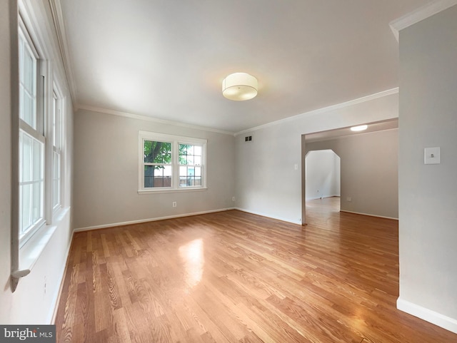 unfurnished room with ornamental molding and light hardwood / wood-style floors