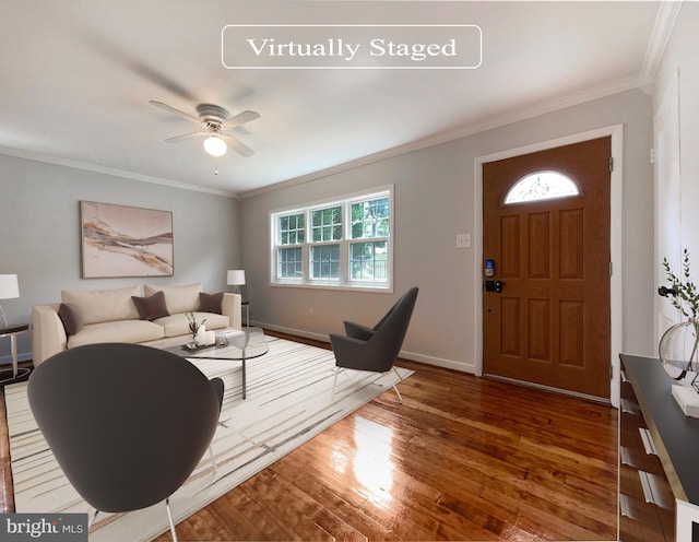 living room with hardwood / wood-style flooring, ceiling fan, and ornamental molding