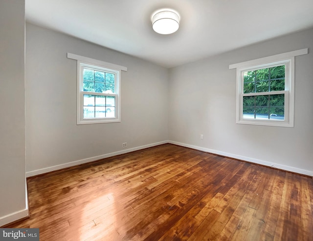 empty room with hardwood / wood-style flooring