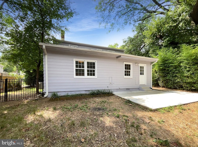 back of property with a patio