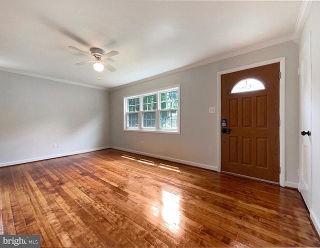 entrance foyer with hardwood / wood-style flooring, ceiling fan, and ornamental molding