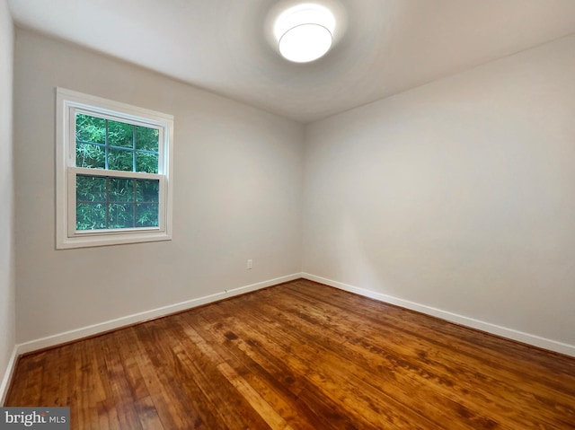 unfurnished room with hardwood / wood-style floors