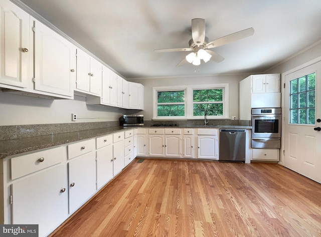 kitchen featuring white cabinetry, stainless steel appliances, light wood-type flooring, and plenty of natural light