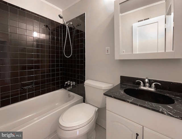 full bathroom featuring vanity, crown molding, toilet, and tiled shower / bath