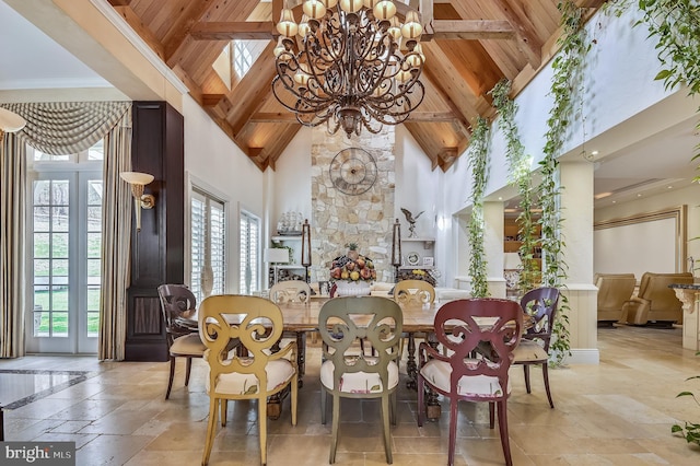 dining space with an inviting chandelier, wood ceiling, high vaulted ceiling, and beamed ceiling