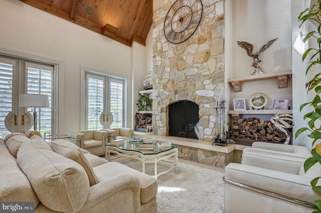 living room with high vaulted ceiling, a fireplace, beamed ceiling, wooden ceiling, and french doors