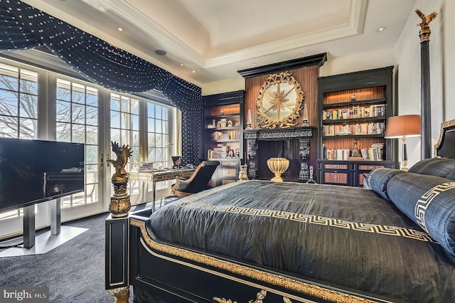 carpeted bedroom with a tray ceiling