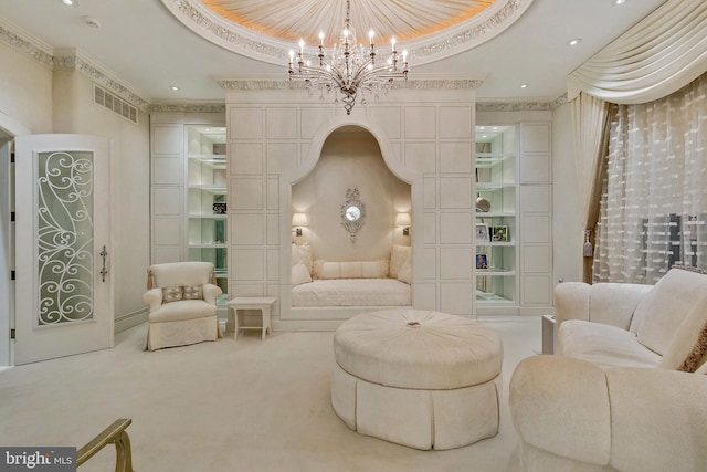 living area featuring light carpet, ornamental molding, a raised ceiling, and an inviting chandelier