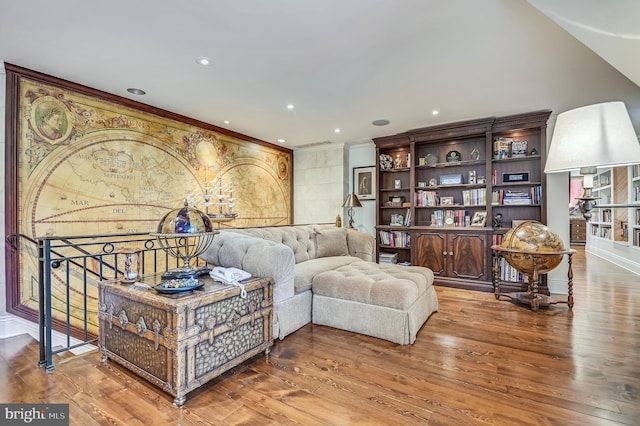 sitting room featuring wood-type flooring and ornamental molding