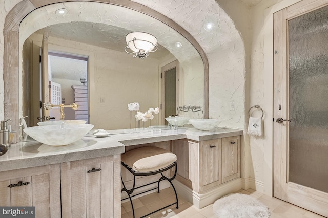 bathroom featuring tile patterned flooring and vanity