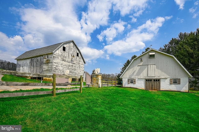 view of side of property with a yard and an outbuilding