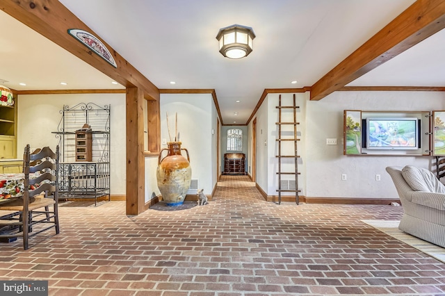 foyer featuring crown molding and beam ceiling