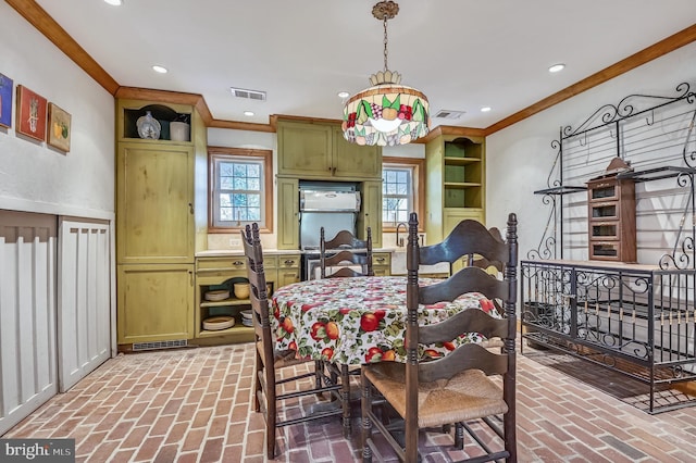 dining room featuring crown molding and plenty of natural light