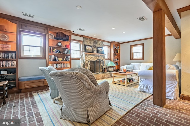 living room with ornamental molding and a fireplace