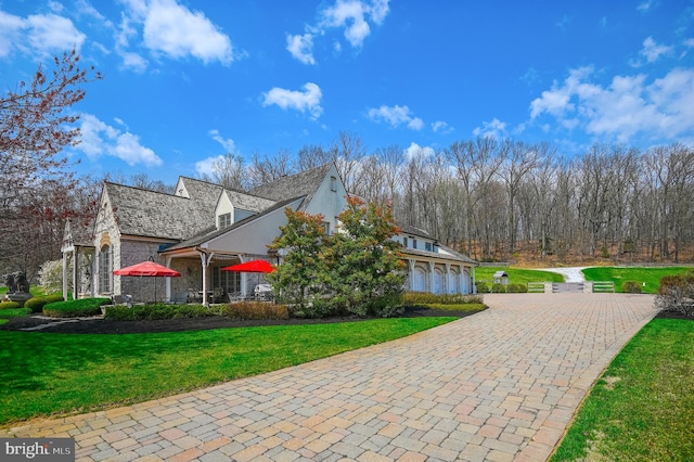 view of side of property with a garage and a lawn