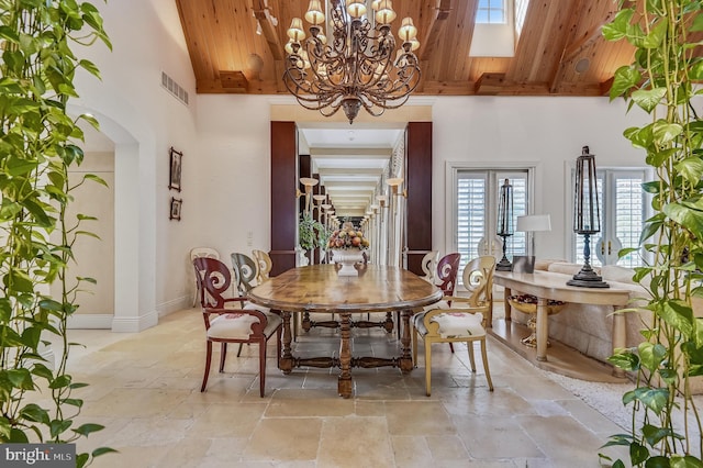 dining room featuring beamed ceiling, high vaulted ceiling, and wooden ceiling