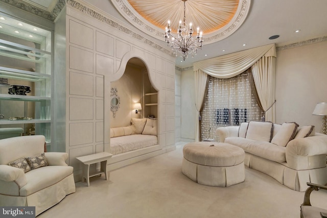 living area featuring crown molding, an inviting chandelier, a towering ceiling, carpet, and built in shelves