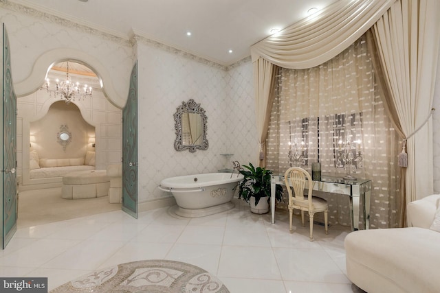 bathroom featuring an inviting chandelier, crown molding, tile patterned floors, and a bathing tub