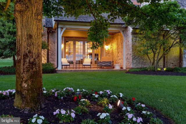 doorway to property with a lawn